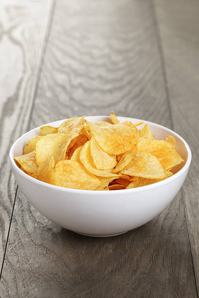 istock organic potato chips in white bowl on wood table 478871218
