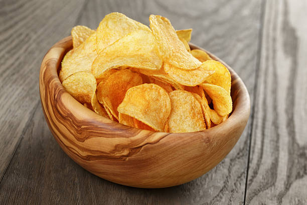 istock organic potato chips in bowl on wood table 478871220
