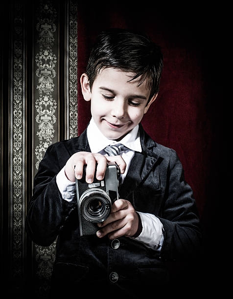 istock Child taking pictures with vintage camera 478873455