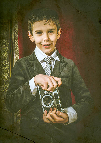 istock Child taking pictures with vintage camera 478873461