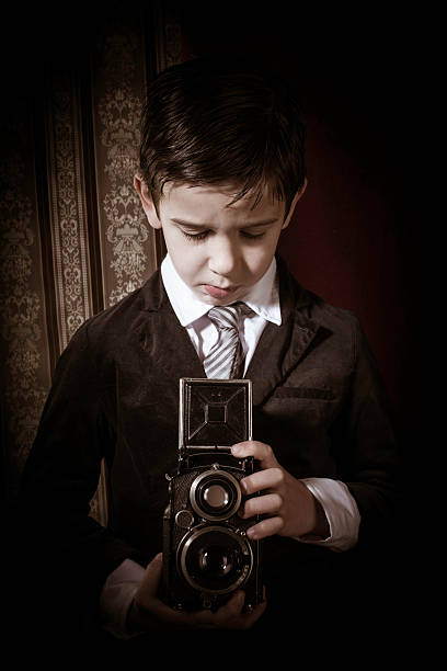 istock Child taking pictures with vintage camera 478874183