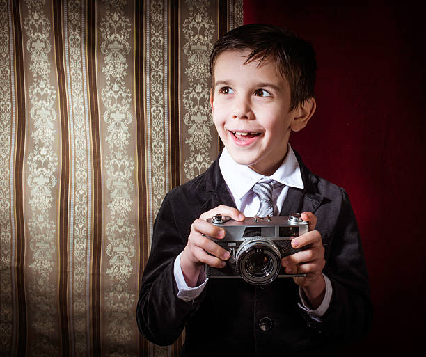 istock Child taking pictures with vintage camera 478876821