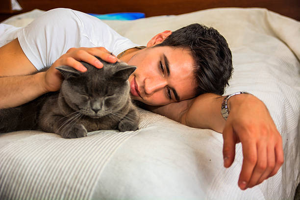 istock Handsome Young Man Cuddling his Gray Cat Pet 478878348