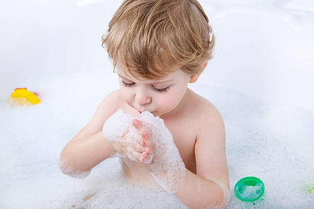 istock Lovely child splashing and playing with foam 478878610