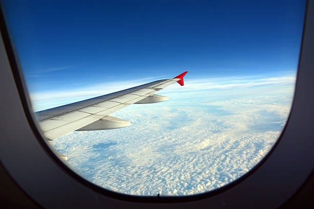 istock Wing of an airplane flying above the clouds 478879426