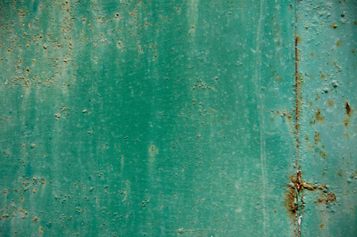 green metal surface of a plank dirty and rusty on the bottom - worn blank background