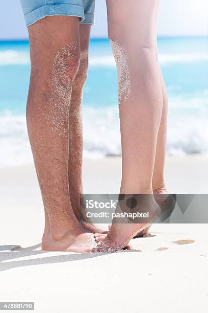 Couple Of Male And Female Legs On Beach Stock Photo - Download Image Now - 2015, Adult, Backgrounds