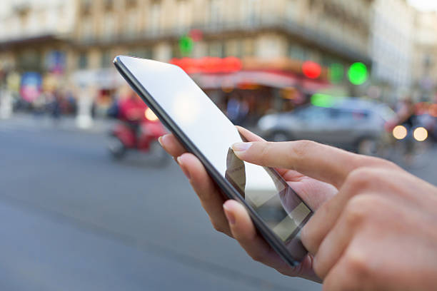 istock Woman using her Mobile Phone in the street 478882462