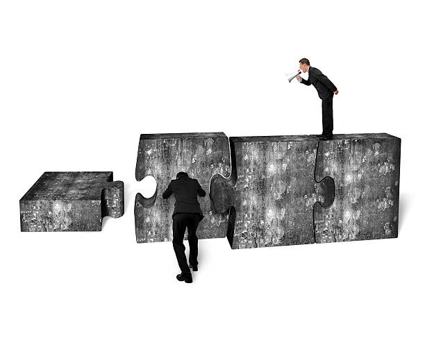istock Businessman speaker yelling other pushing jigsaw puzzle concrete 478882720