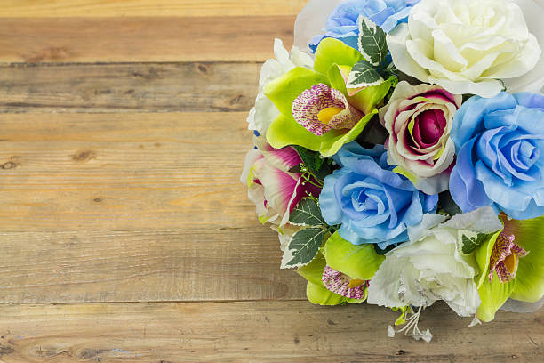 istock Artificial flowers on wooden background 478883238