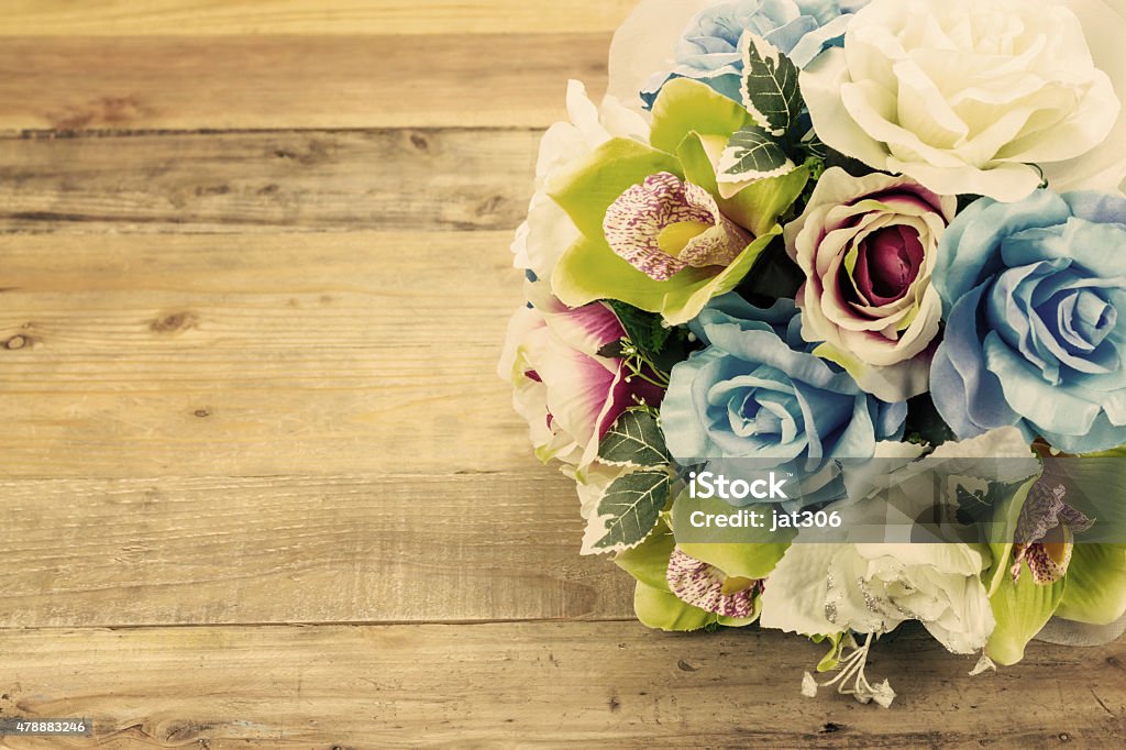 Artificial flowers on wooden background, Vintage effect 2015 Stock Photo