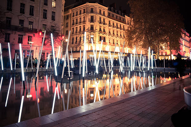 Festival of Lights - fête des lumières - in Lyon, France.On December 8th, the monuments are illuminated, here Morand bridge and Basilica Notre Dame de Fourviere in background. The origins of this festival date to 1643, in honor of the Virgin Mary who protected the city from the plague. Since then, the city has been illuminated every year, around December 8th.