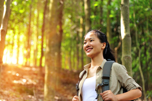 young woman hiker hiking in forest