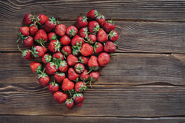 istock Fresh fruit of strawberries on old wooden table 478884520