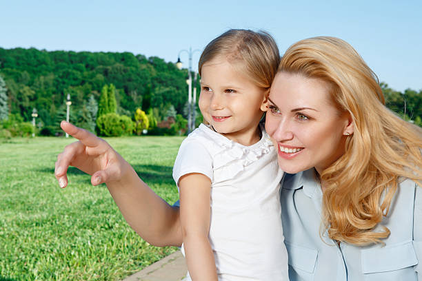 istock Young mother showing something to her daughter 478892034