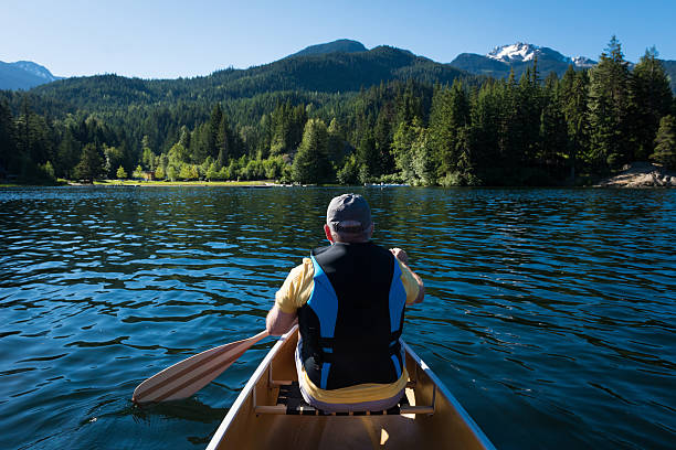 istock Senior canoeing on a pristine lake 478896186