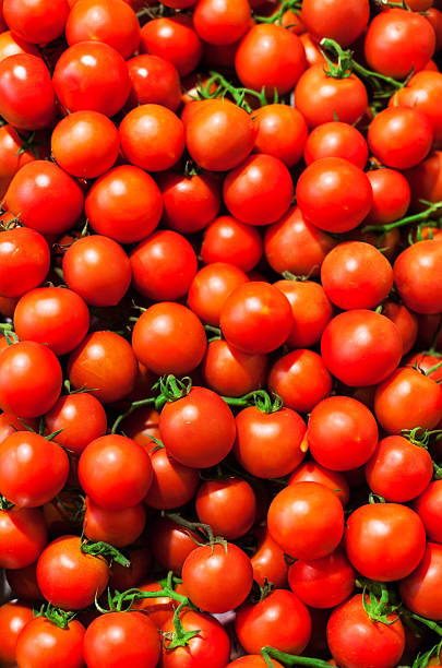 istock Red Cherry tomatoes in market close up as background. 478898666