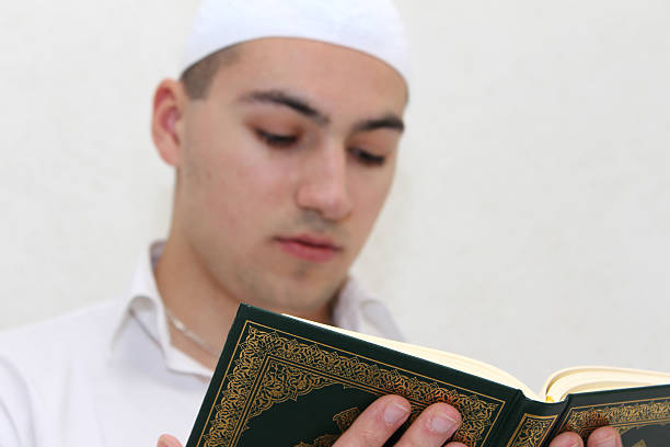 istock Young Muslim Guy Reading The Koran 478901570