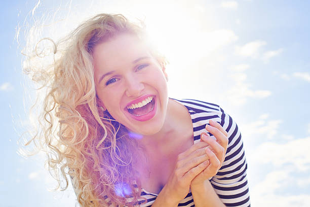 Portrait of an excited young woman standing against a blue skyhttp://195.154.178.81/DATA/i_collage/pu/shoots/805064.jpg