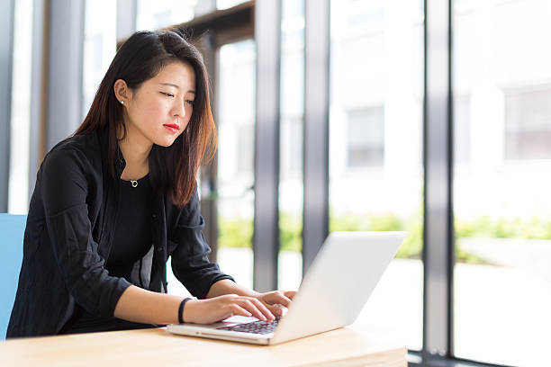 istock Asian student sitting with a laptop at the campus 478907304