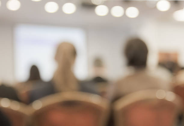 Blurred image of people in auditorium , blur with bokeh