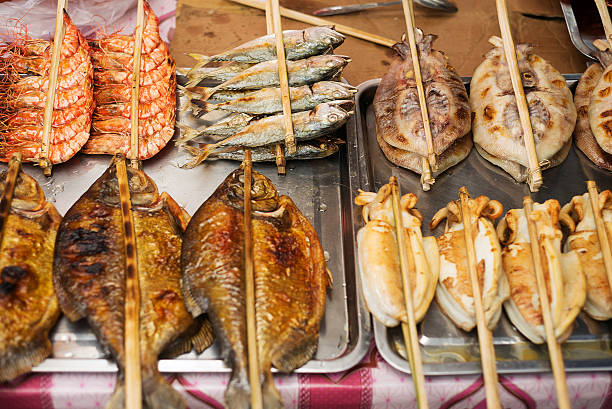 asian grilled barbecued seafood in kep market cambodia asian grilled barbecued mixed seafood in kep market cambodia kep stock pictures, royalty-free photos & images