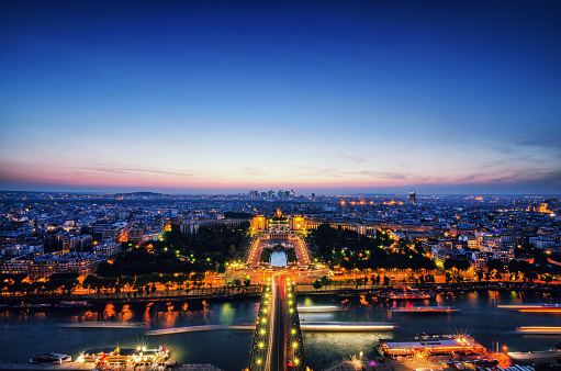 Aerial Night view of Paris City and Seine river shot on the top of Eiffel Tower.