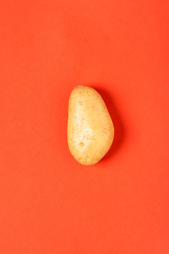 Potato on red paper