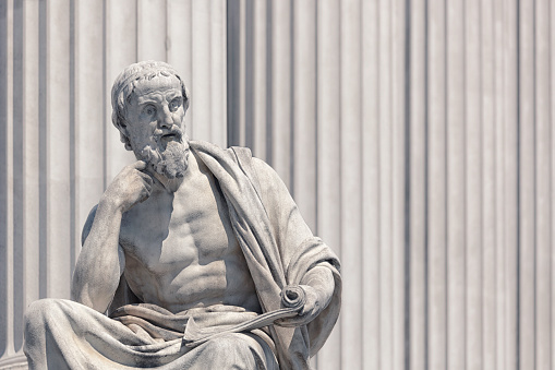 Sculpture of Herodotus in classical greek style. Several greek classical style statues decor the exterior of the Austrian parliament building, completed in 1883 by the architect Theophil Hansen (1813-1891).