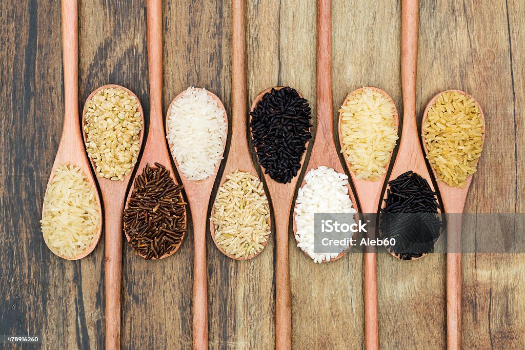 Types of rice Different types of rice over a wooden spoon. 2015 Stock Photo