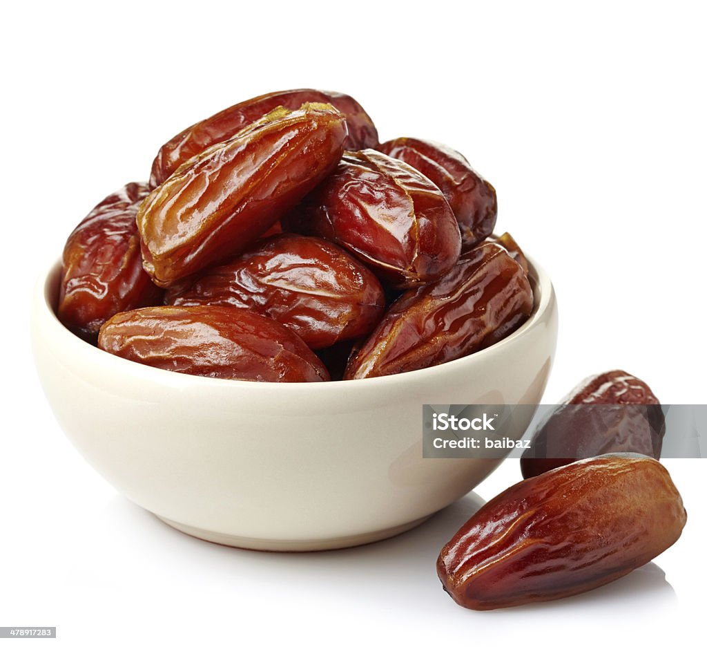 Dried dates Bowl of dried dates isolated on white background Date - Fruit Stock Photo