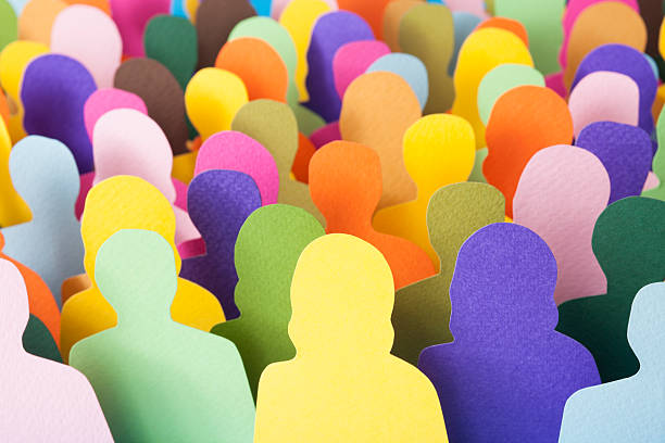 Anonymous crowd Lots of multicolored men and women silhouettes made with paper for crowd concept vibrant group stock pictures, royalty-free photos & images
