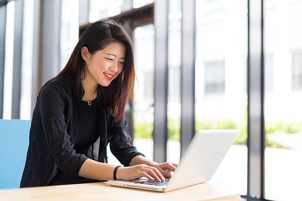 istock Asian college student sitting with a laptop 478918820