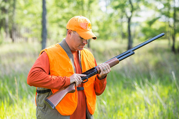 istock Man in woods hunting with shotgun 478919592