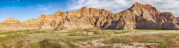 South Dakota Badlands Panorama A large-scale panoramic view of a part of Badlands National Park in South Dakota showcases the grasslands and the hills of the area. badlands stock pictures, royalty-free photos & images