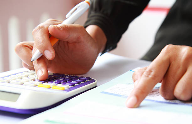 istock Woman's hands with a calculator and a pen 478924115