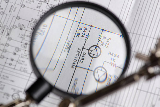 istock the study of the electrical circuit with a magnifying glass 478926548