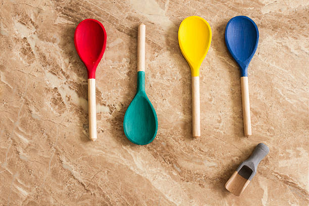istock red yellow blue and green wooden spoons 478929222