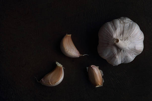 istock Garlic cloves on the black table. Top view 478931770