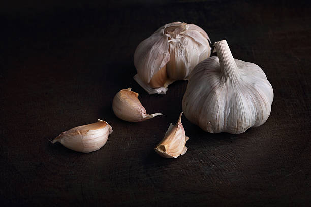 istock Garlic cloves on the black wooden table 478931776