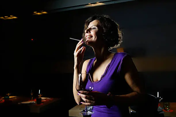 Attractive lady with cigarette in nightclub