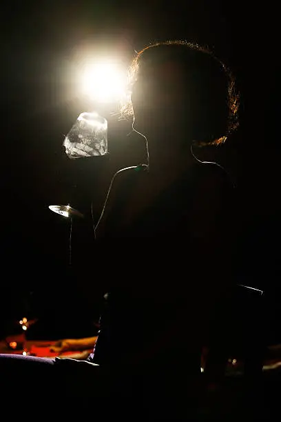Silhouette of a woman drinking and partying in nightclub