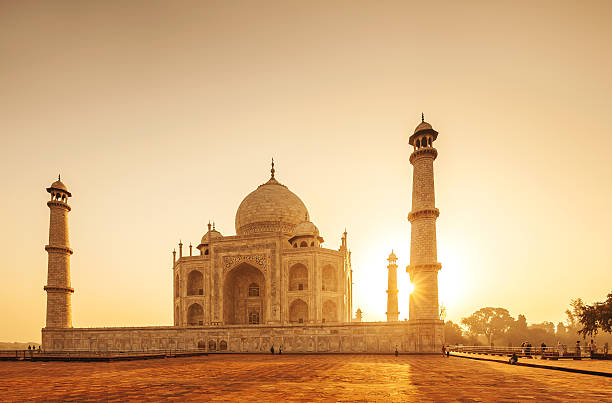 Taj Mahal Sunset, India The Taj Mahal is a mausoleum located in Agra, India. It is one of the most recognizable structures in the world. Taj Mahal is regarded as one of the eight wonders of the world. india indian culture taj mahal temple stock pictures, royalty-free photos & images