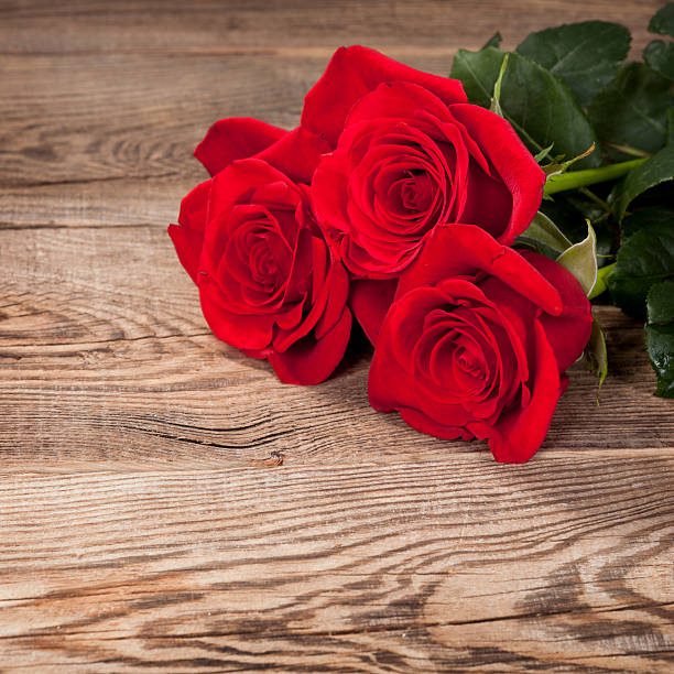 istock Beautiful red roses on the old board 478937972