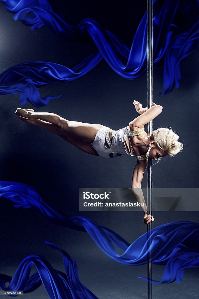 Pole dance. with blue silks pole dancer Active Lifestyle Stock Photo