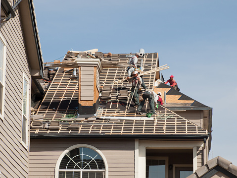 Greenwood Village, Colorado, USA - March 18, 2011: Roof repairs of an apartment building in Colorado.
