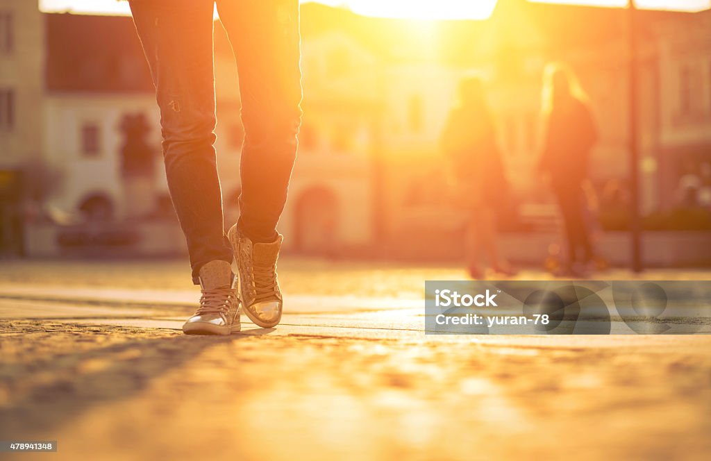 Womansfoots on the street at sunny day. 2015 Stock Photo