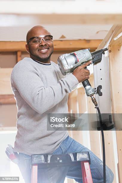 Black Construction Worker With Nail Gun Stock Photo - Download Image Now - 40-49 Years, African-American Ethnicity, Males