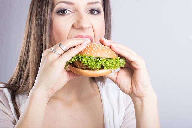 istock Woman holding hamburger 478945797