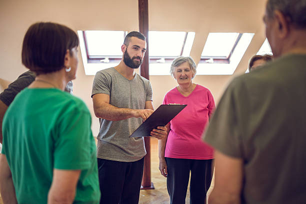istock Young coach making an exercise plan for group of seniors. 478945934